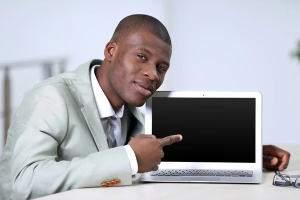 Handsome businessman with laptop — Stock Photo, Image