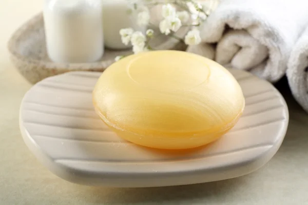 Soap on a dish with towels — Stock Photo, Image