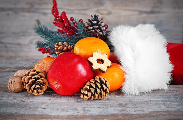 Santa hat filled with Christmas gifts — Stock Photo, Image