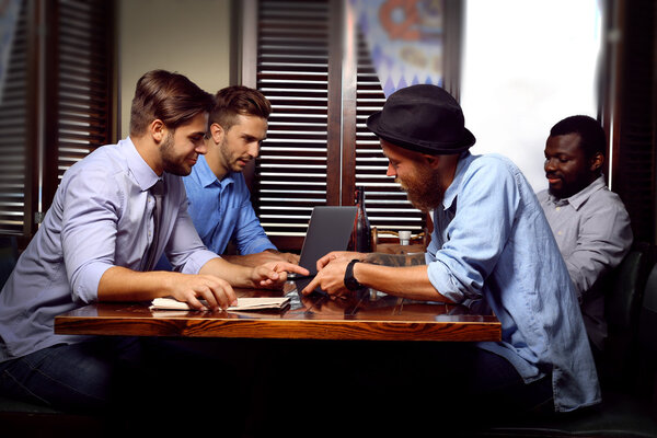 Young men talking in cafe