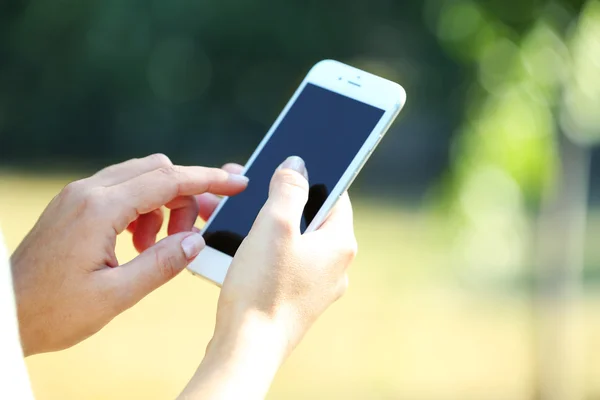 A mobiltelefon tartó női kezek — Stock Fotó