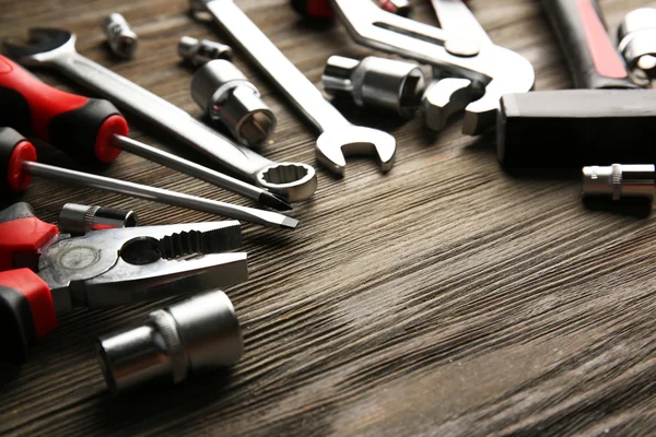 Different kinds of tools on wooden background, top view — Stock Photo, Image