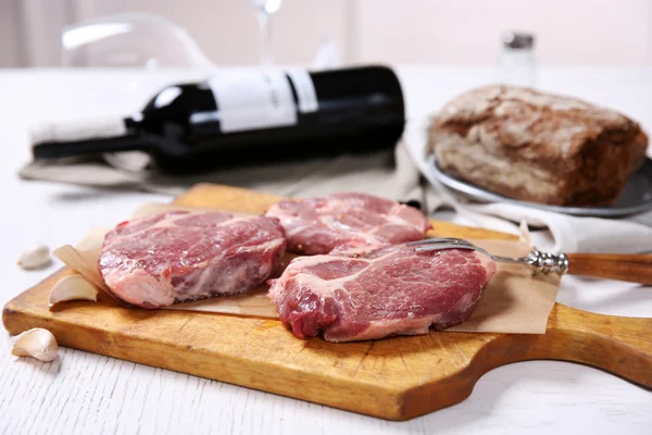 Bife de carne marmorizada com garrafa de vinho e especiarias em fundo de madeira — Fotografia de Stock
