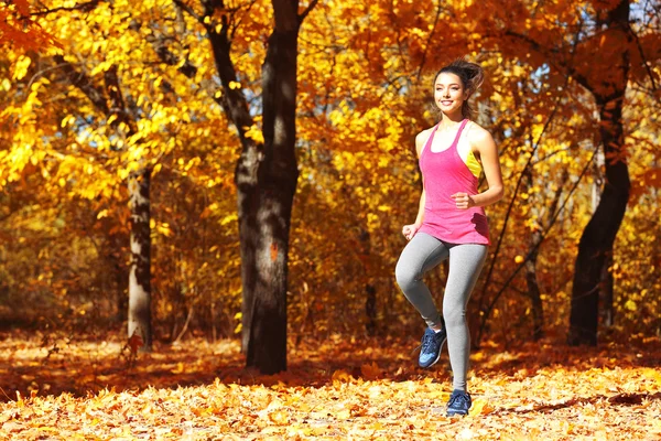 Frau joggt im Herbstpark — Stockfoto