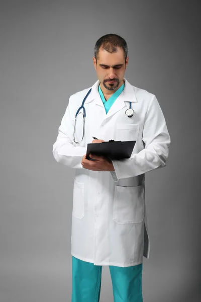 Doctor with prescription board in hands — Stock Photo, Image