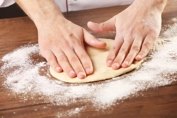 Hands preparing dough basis for pizza — Stock Photo, Image