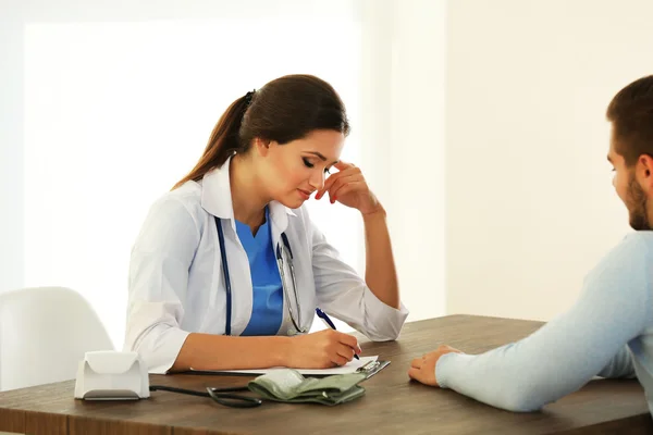 Ženský lékař zkoumá pacienta krevní tlak — Stock fotografie