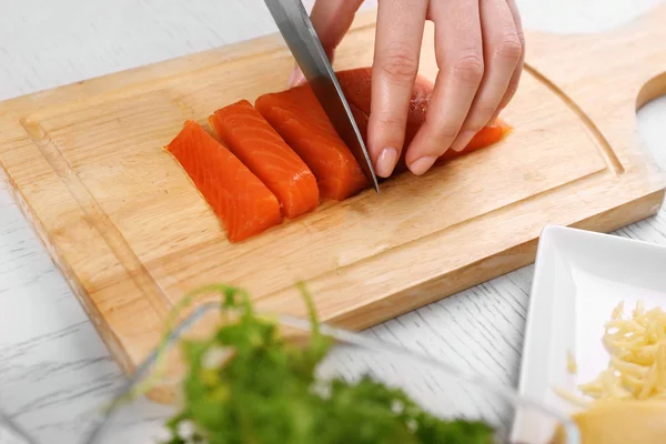 Mujer cortando salmón ahumado —  Fotos de Stock