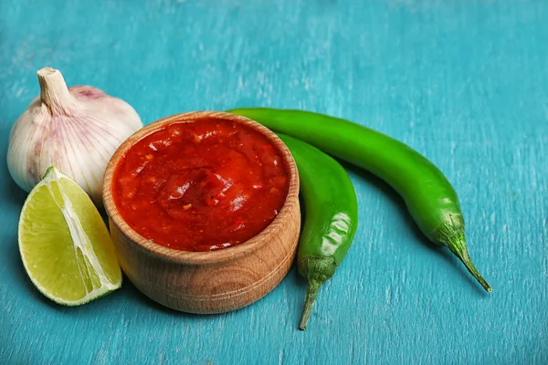 Homemade sauce salsa and spices on color wooden background — Stock Photo, Image