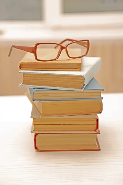 Pile of books and eyeglasses on it, close up — Stock Photo, Image