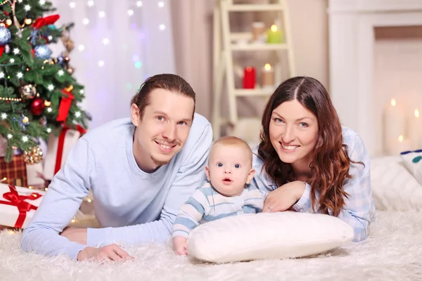 Happy family laying on floor — Stock Photo, Image