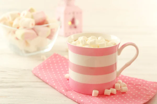 Mug of hot chocolate with marshmallows, on light wooden background — Stock Photo, Image