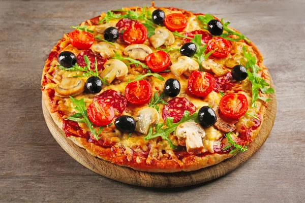 Delicious tasty pizza on wooden table — Stock Photo, Image