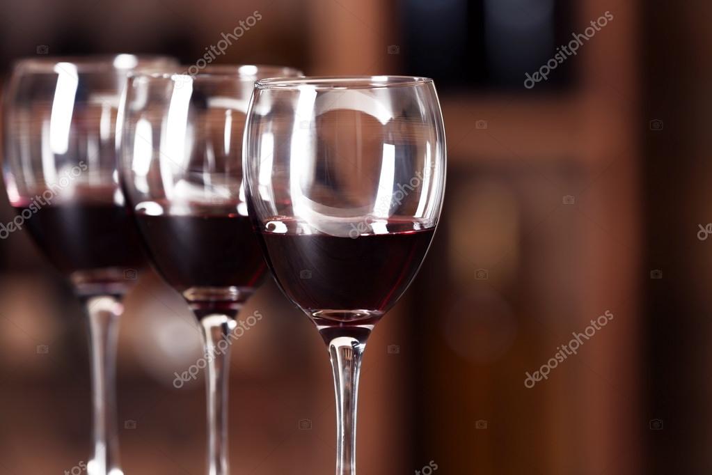 Glasses with red wine in cellar Stock Photo by ©belchonock 95439724
