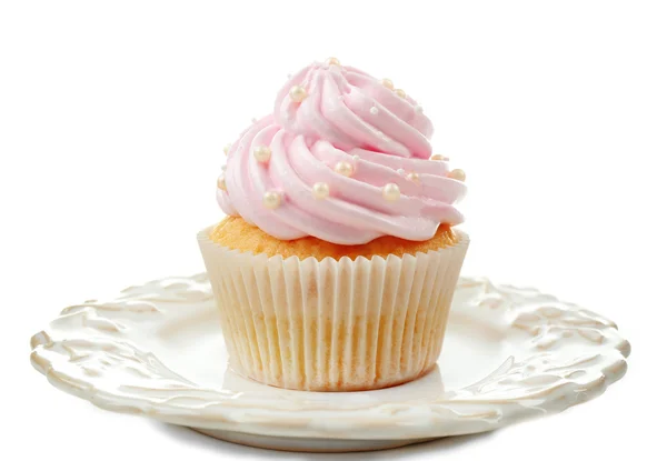 Cupcake rosa na placa isolada no branco — Fotografia de Stock