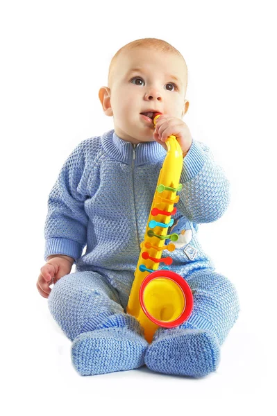 Adorable baby with plastic colourful saxophone — Stock Photo, Image