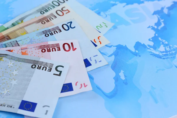 Different euro banknotes on a map background — Stock Photo, Image