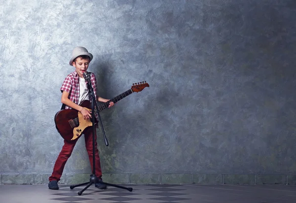Malý chlapec s kytara zpěv — Stock fotografie