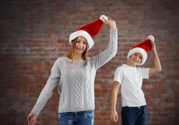 Happy cousins have fun  in santa hat — Stock Photo, Image