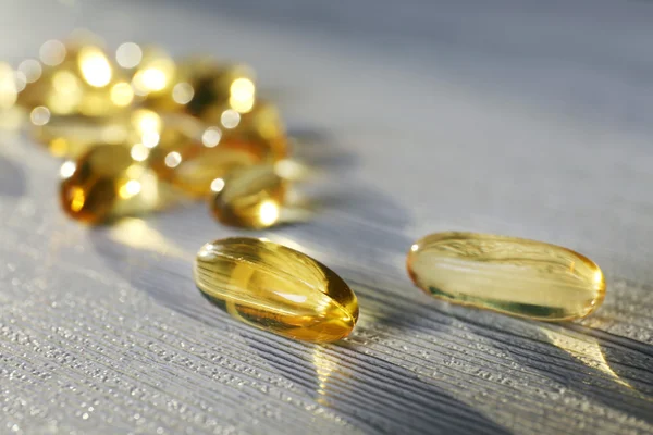 Transparent yellow pills — Stock Photo, Image