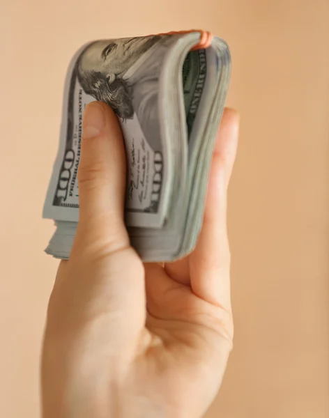 Hand holding a pack of dollars — Stock Photo, Image