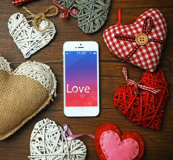 White smart phone with hearts — Stock Photo, Image