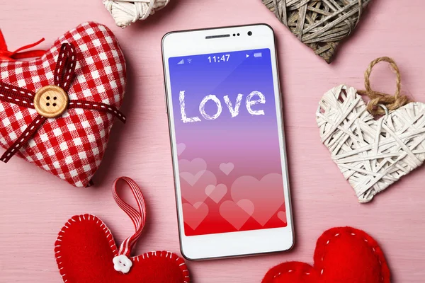 White smart phone with hearts — Stock Photo, Image