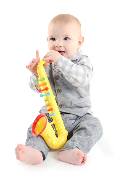 Adorable baby with plastic colourful saxophone — Stock Photo, Image