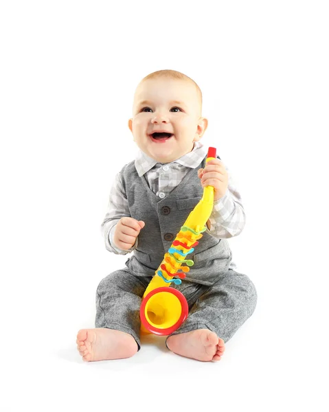 Adorable baby with plastic colourful saxophone — Stock Photo, Image