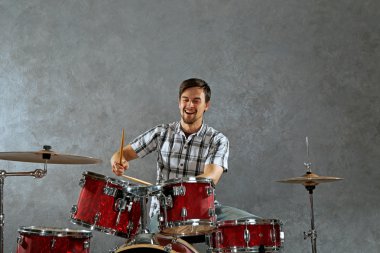 Musician playing drums clipart