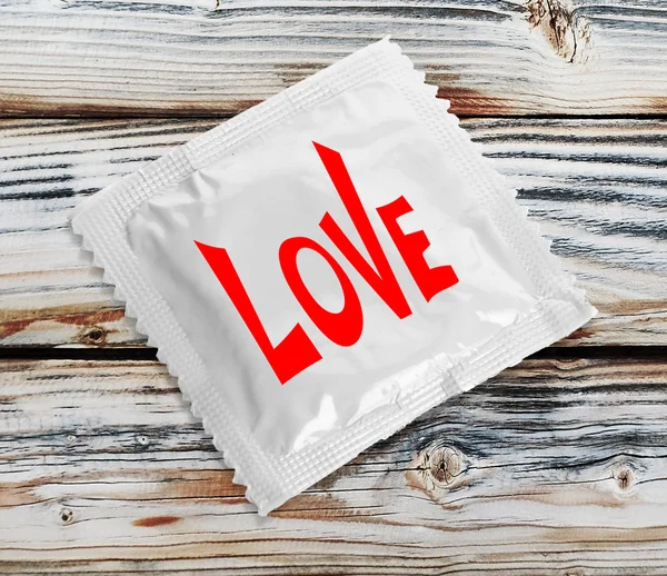 Condom with text Love — Stock Photo, Image