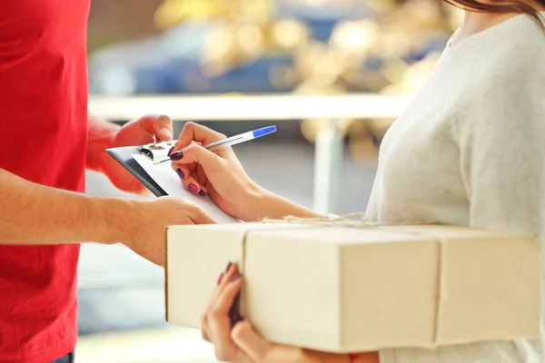 Woman signing delivery receipt