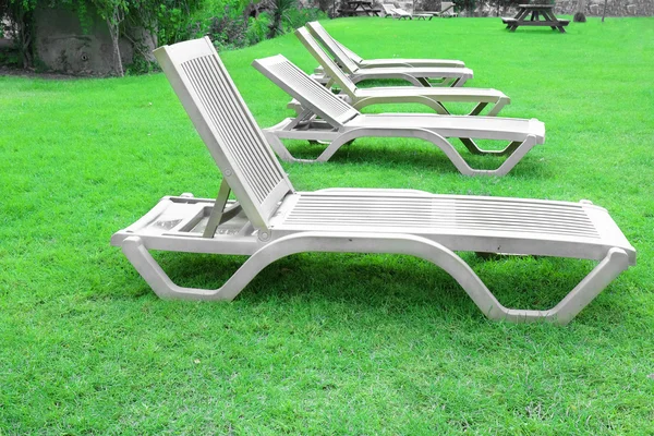 Chaise longues on green grass — Stock Photo, Image