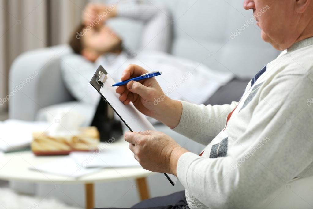 Man lying on sofa at psychologist