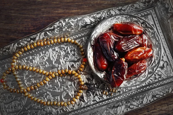Dates fruit and rosary on beautiful tray, close up — Stock Photo, Image