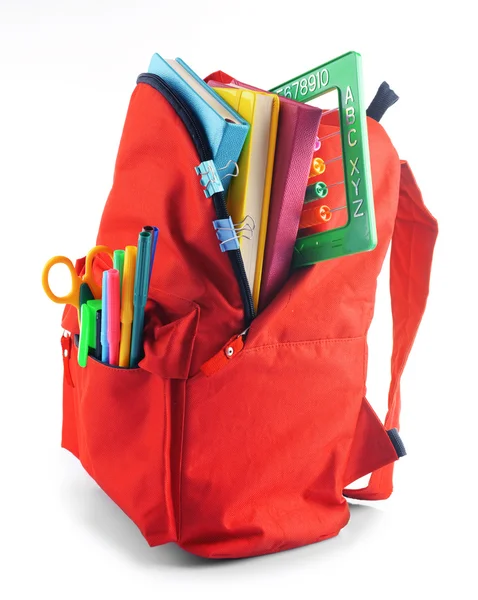 Röd ryggsäck med färgglada stationära — Stockfoto