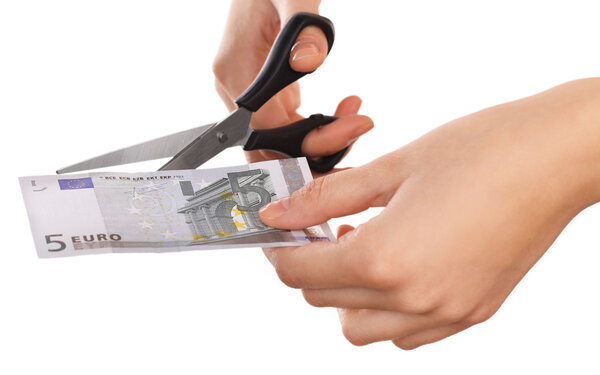Hands with scissors cutting Euro