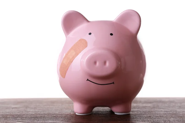 Piggy bank met zelfklevend verband — Stockfoto