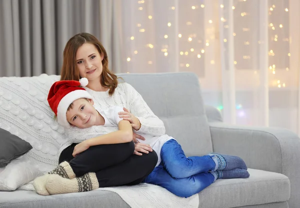 Mother with son sitting on sofa — Stock Photo, Image