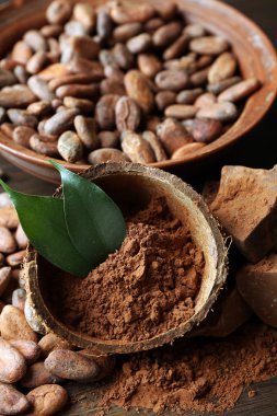 Aromatik kakao tozu ve ahşap zemin üzerine yeşil yaprak kase, yakın çekim