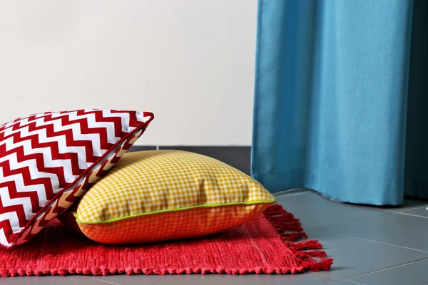 Multicoloured pillows on a carpet — Stock Photo, Image