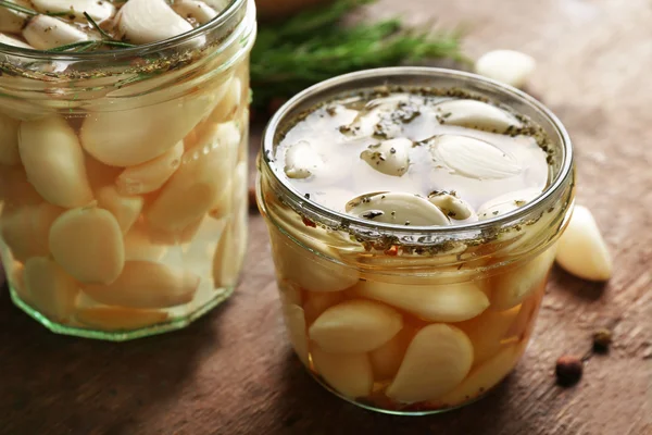 Garlic with spices on wooden table — Stock Photo, Image