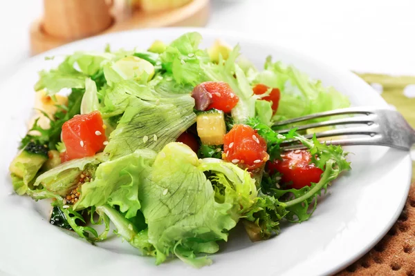 Tasty salmon salad on light wooden background — Stock Photo, Image