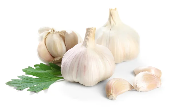 Garlic with leaves of parsley isolated on white — Stock Photo, Image