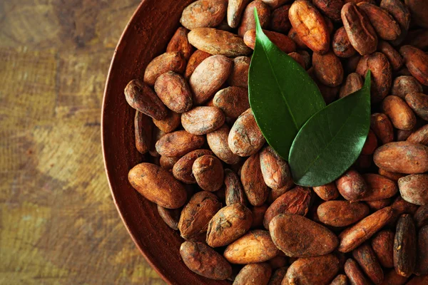 Aromatic cocoa harvest on wooden background, close up — Stock Photo, Image