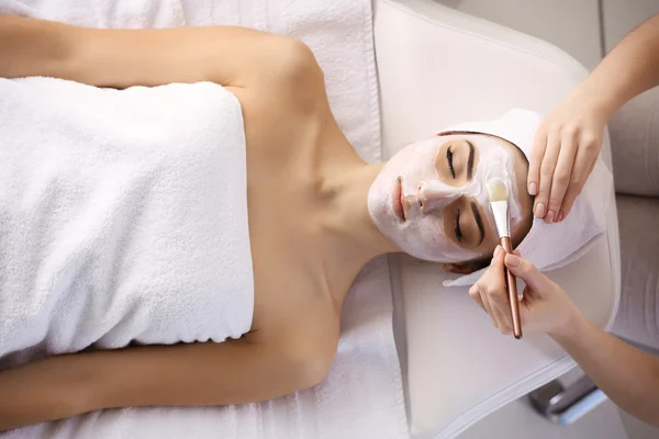 Young woman with facial mask — Stock Photo, Image