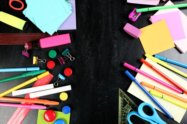 Colourful stationery on black — Stock Photo, Image