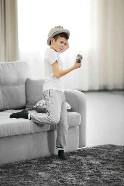 Маленький хлопчик у капелюсі співає — стокове фото