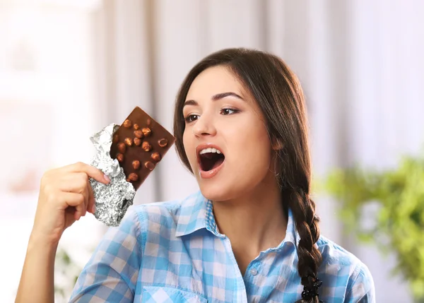 Young brunette with chocolate — Stock Photo, Image