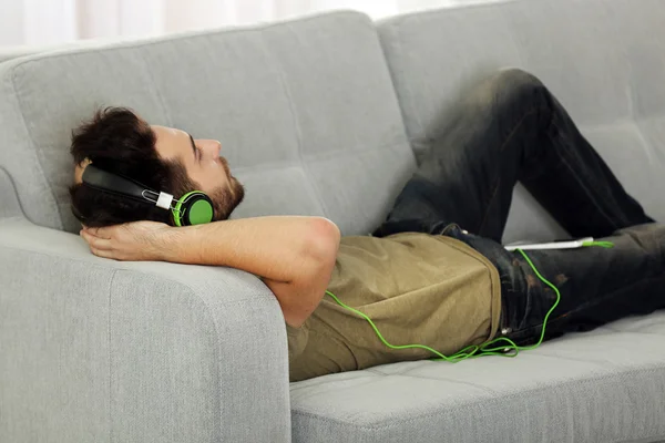 Young man listens music with headphones — Stock Photo, Image